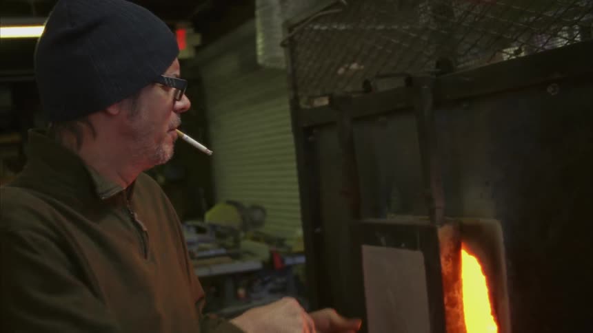 A man is using a forge
