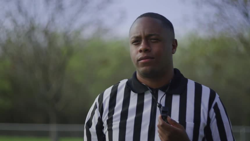 Referee signals a fault and blows the whistle before running away