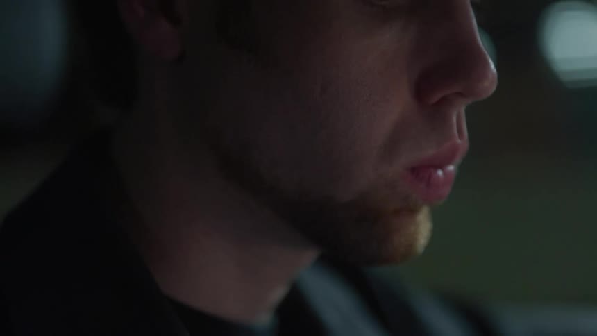 A man rubs his chin with his fingers as he thinks