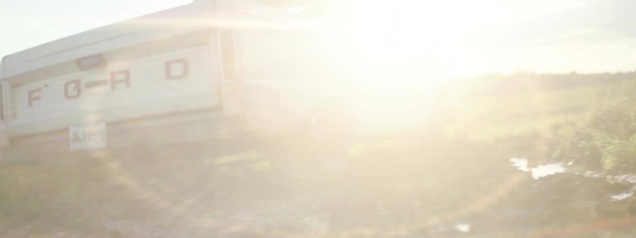 A truck spins its wheels and frees itself from the mud