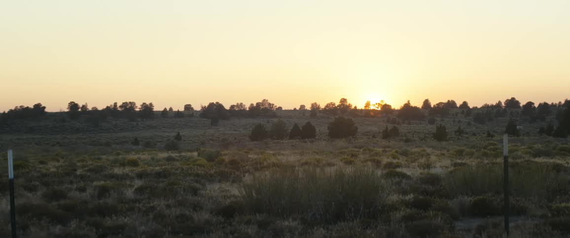 The sun sets over a high desert vista