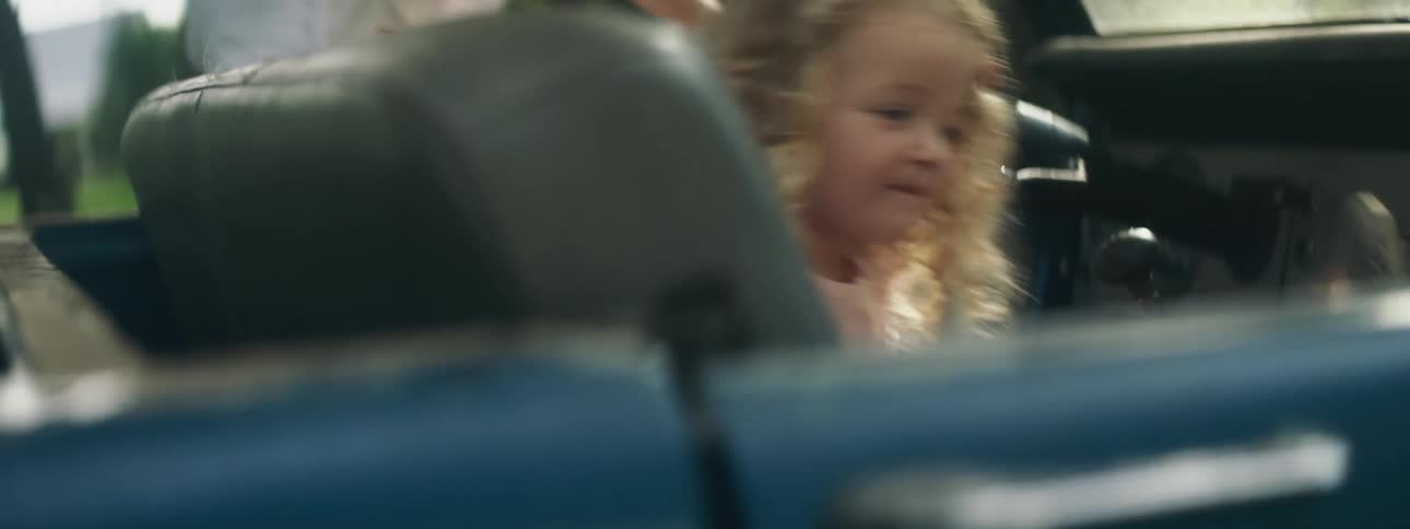 Two young girls getting into a car
