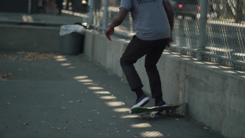 A skateboarder jumps on a ledge