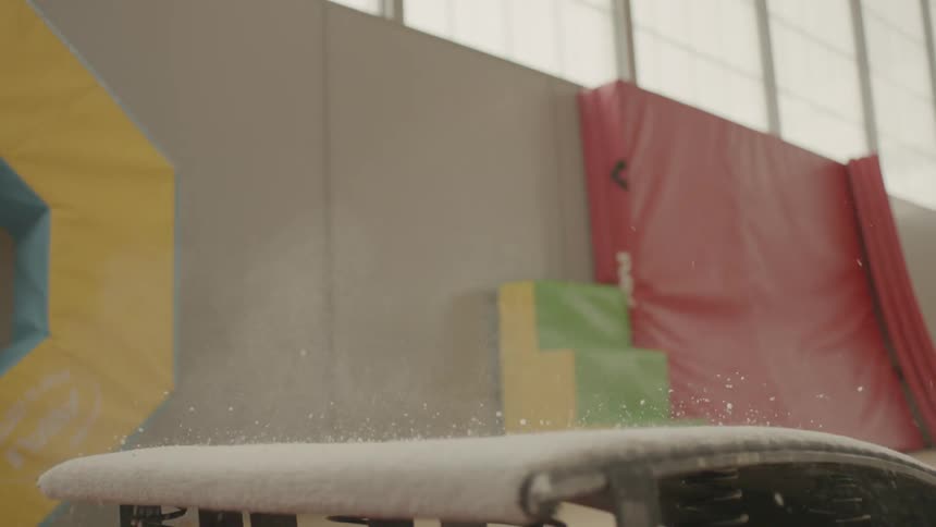 A gymnast jumping into the air
