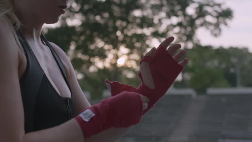 Woman wrapping up her hands before exercising