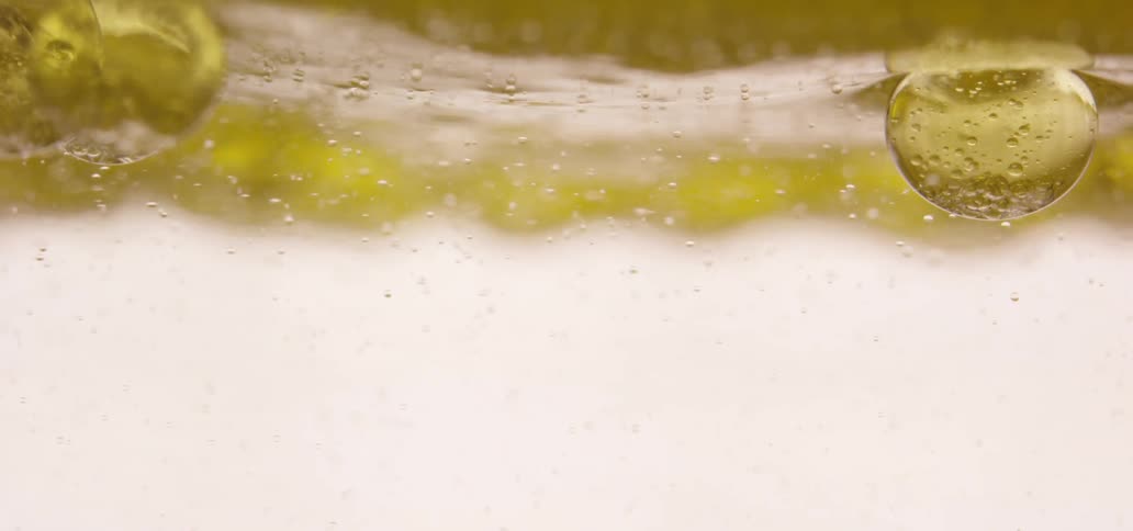 Small yellow bubbles float in water