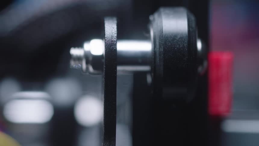 Machine arm moves down as black disc rotates on metal cylinder