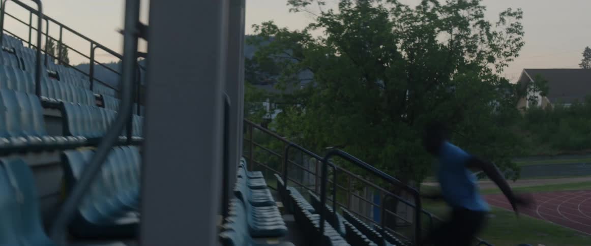 A man runs up stadium stairs