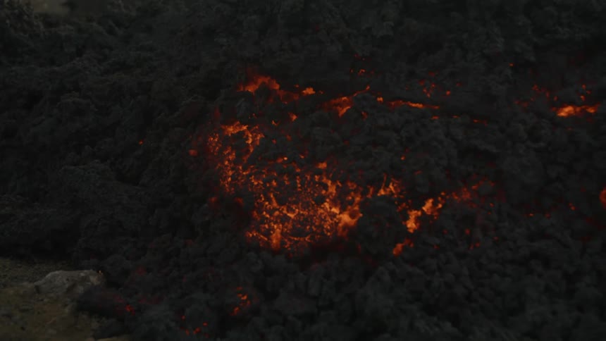 Lava glows through black ash