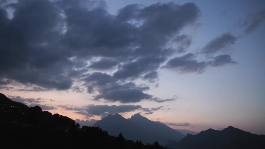 The mountains are dark at sunset