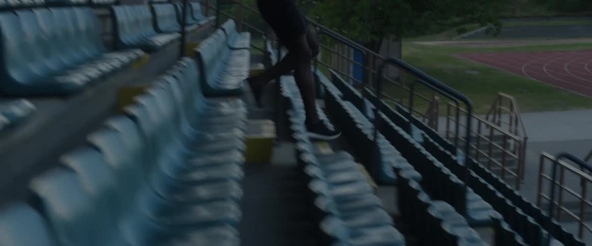 A man runs down stadium steps