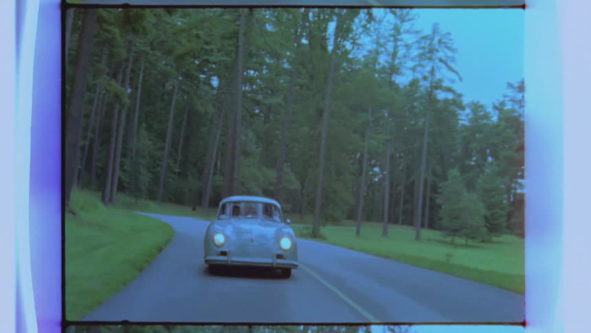 A car is driving down a road