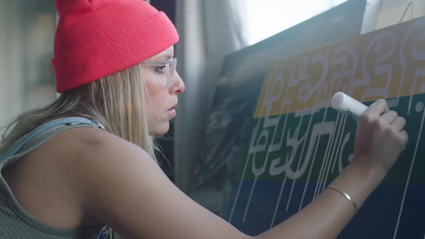 A woman painting on a canvas