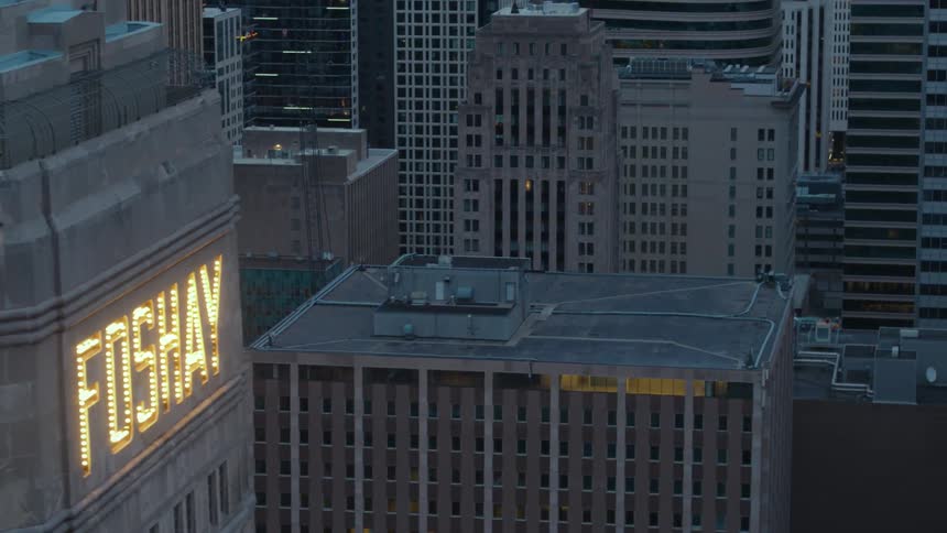 Bright led lights display the name of a tall skyscraper and make it stand out downtown