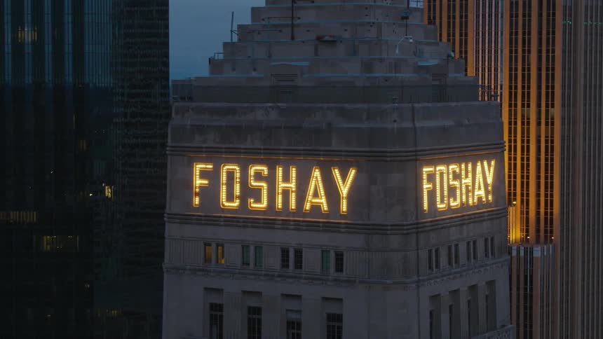The foshay tower in minneapolis with name in lights at dusk