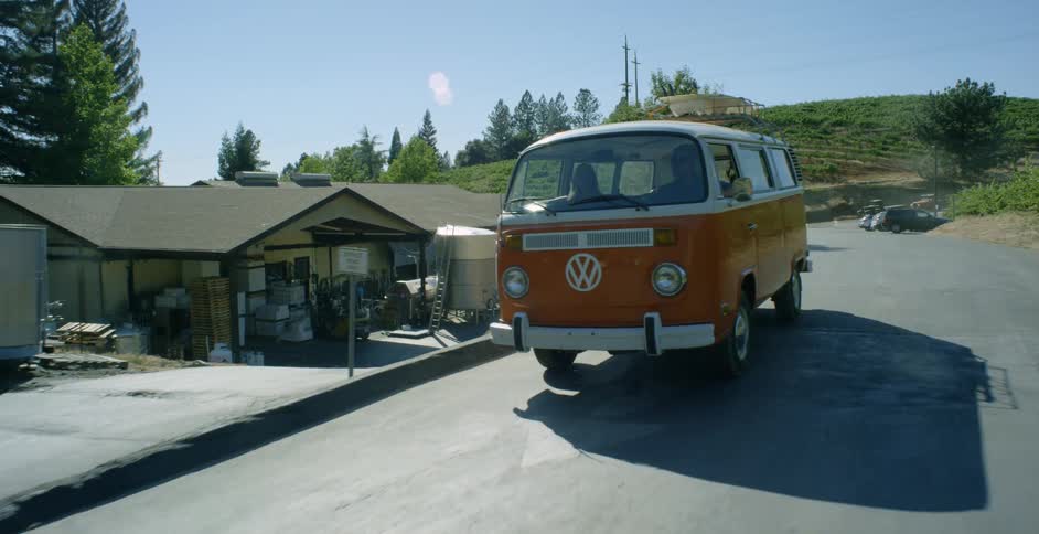 An old van is driving down the road