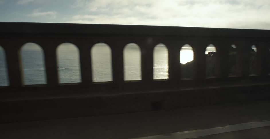 Boats travel in the water over the bridge