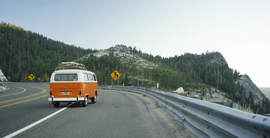 The van is driving down the road