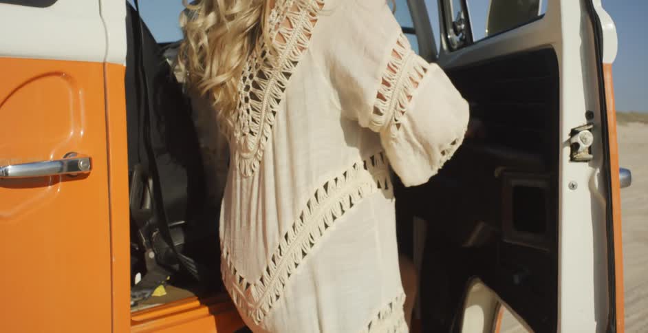 A woman climbs into a vehicle