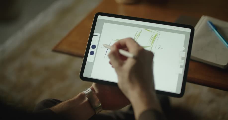 A person is drawing on his tablet