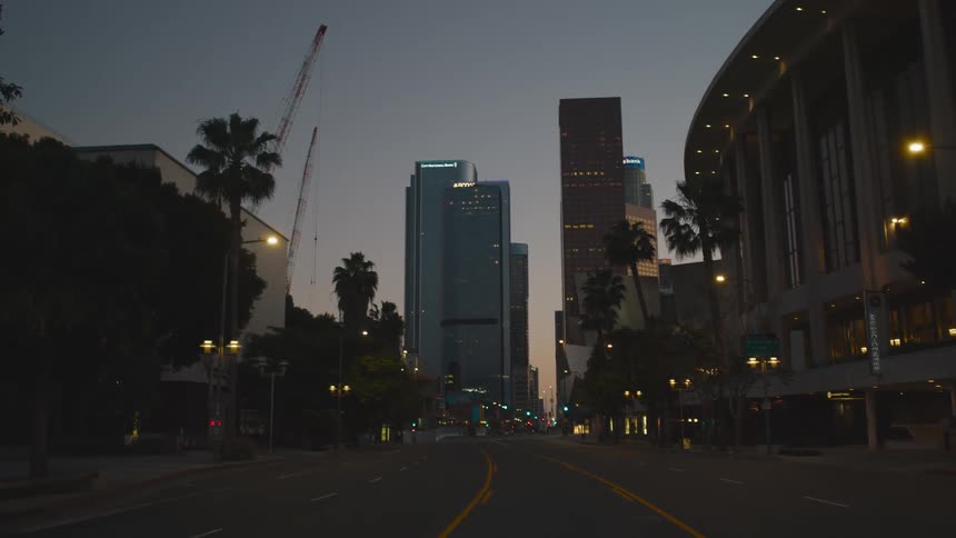 A city street at dusk with no traffic or pedestrians