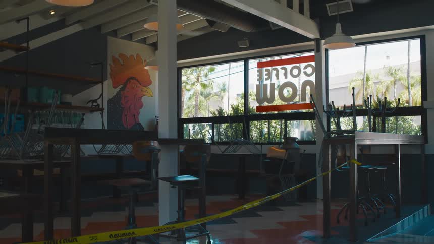Yelllow caution tape on a coffee shop at daytime
