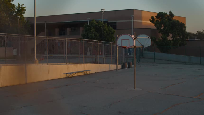 An empty school is shown at dusk