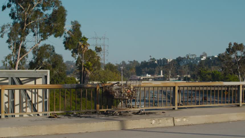 A view of a highway from a bridge that runs over it