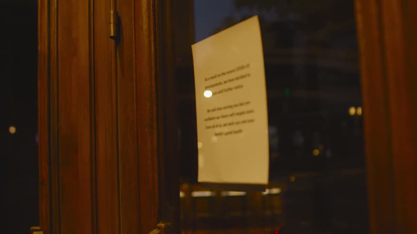 A notice hangs on the door of business