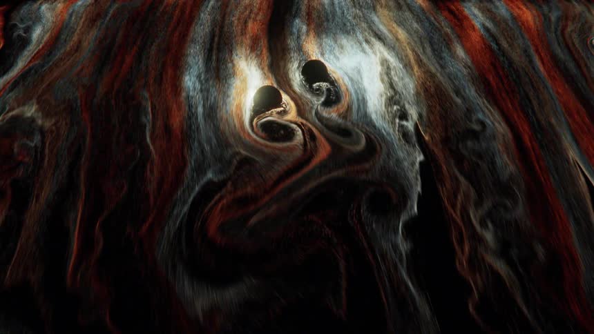 Bright shimmering ink flowing and swirling around two spheres over a black background