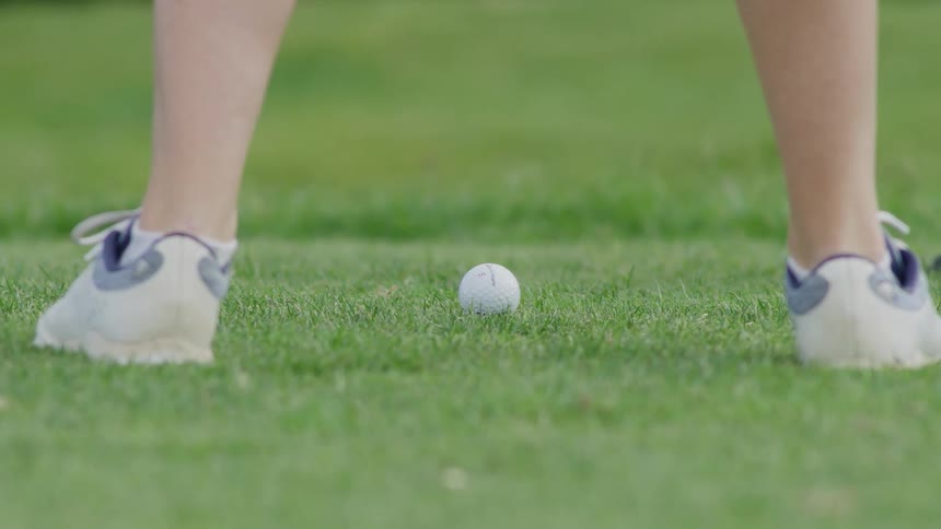 A person is playing golf outdoors in spring