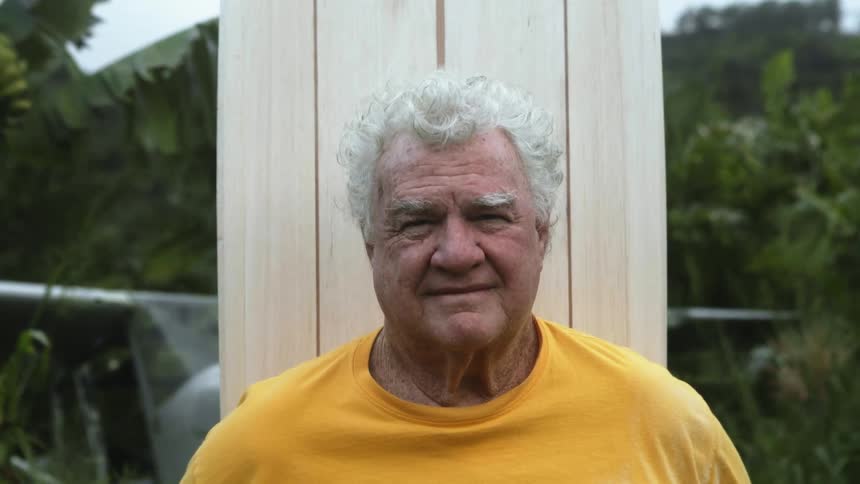 A portrait of a man standing outside