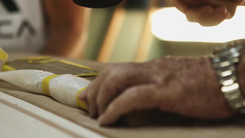 A carpenter hammers on wood