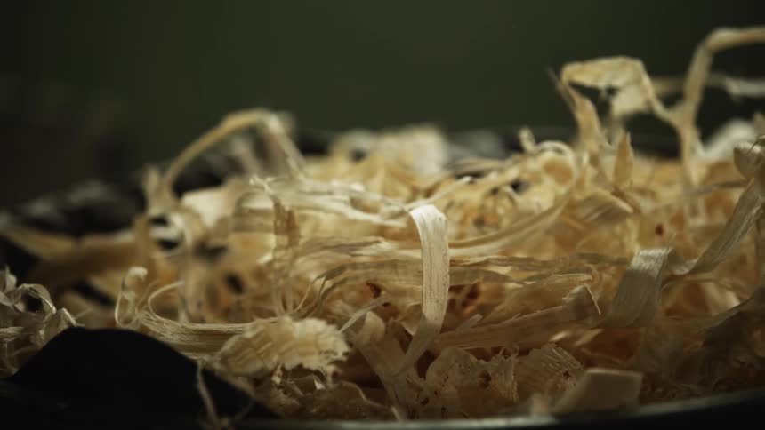 Sawdust wood shavings small chippings of wood falling into a container
