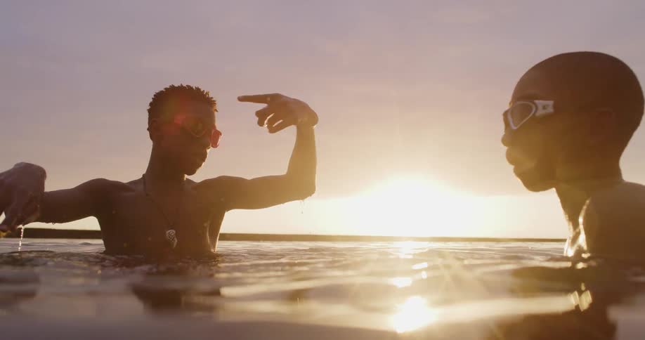 A man and child swimming out in the ocean
