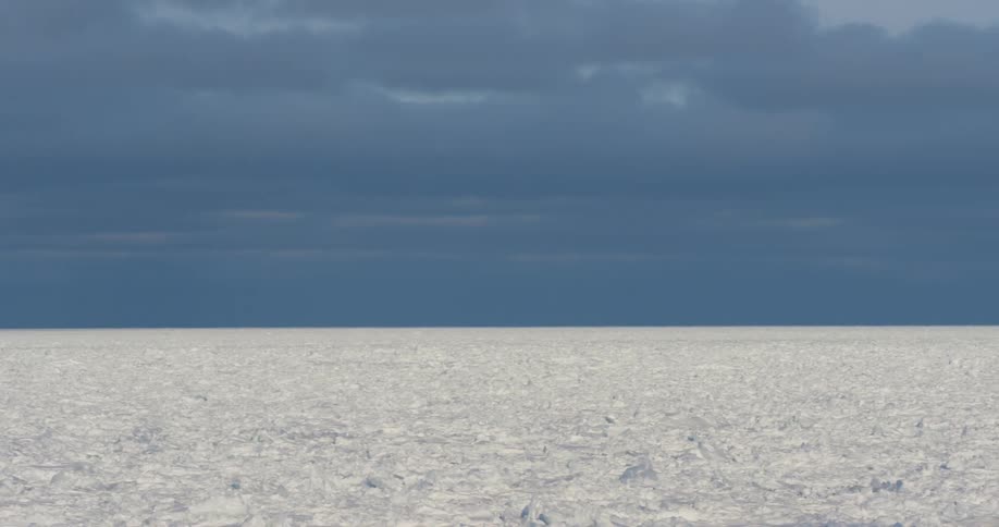 A landscape with ice and snow with the sky and clouds in the background