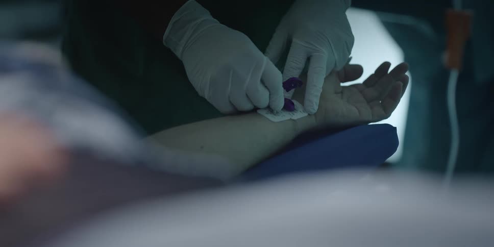 Surgeon attaching monitor sensors on a patients wrist in the surgery room