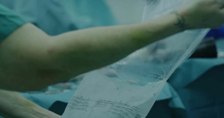 Person grabbing bag in operating room