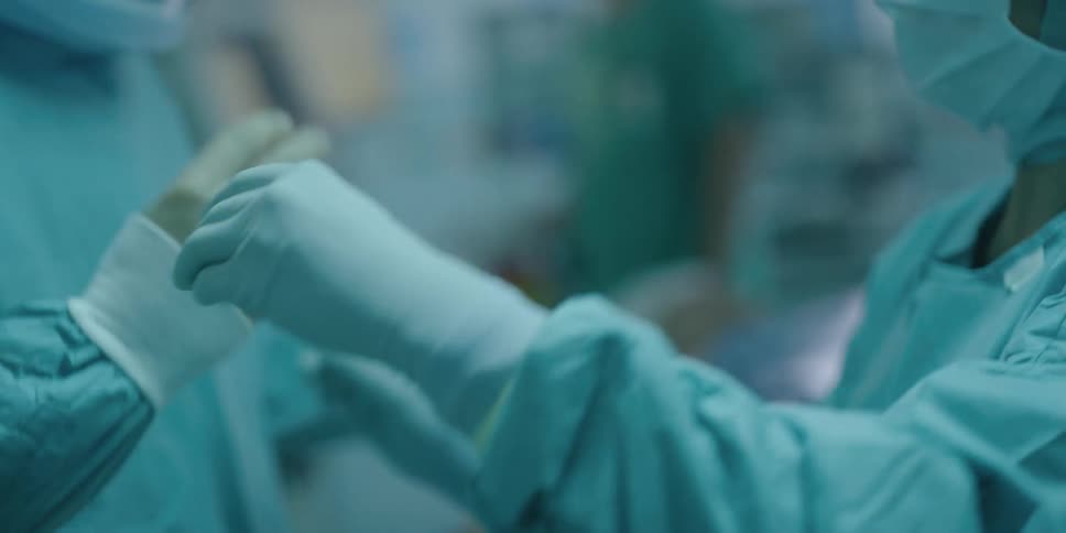 Doctors are putting on medical equipment