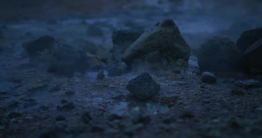 Lava is boiling and steaming next to rocks