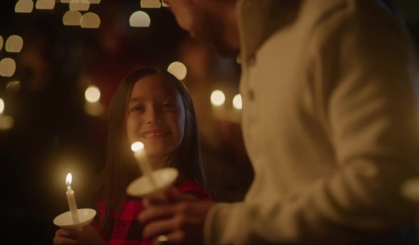 A man and child lighting candles