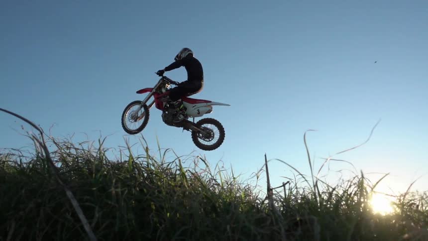 A motorcycle does a jump
