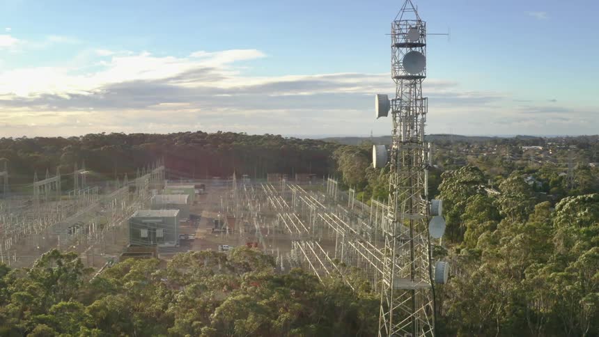 A utility power company with a tower high in the sky