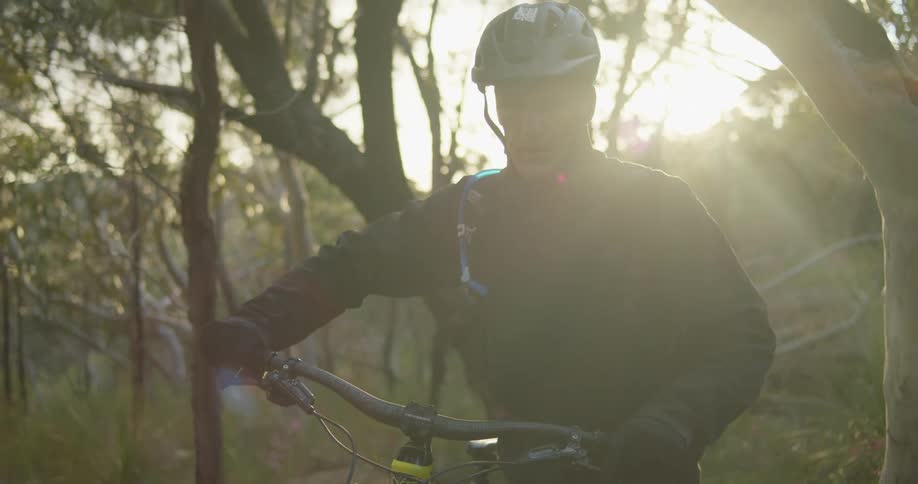 A man is pushing his bicycle up the hill