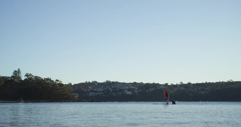 A man paddle boarding on a lake