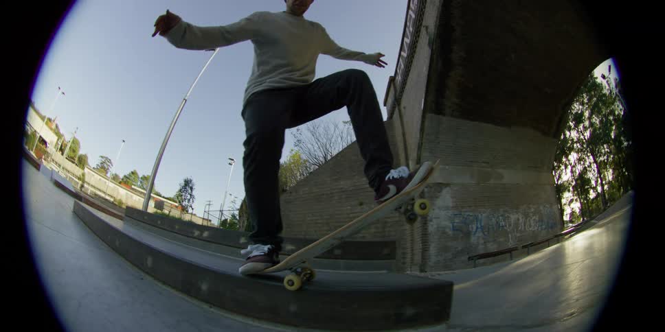 A man is skateboarding at a park during the day