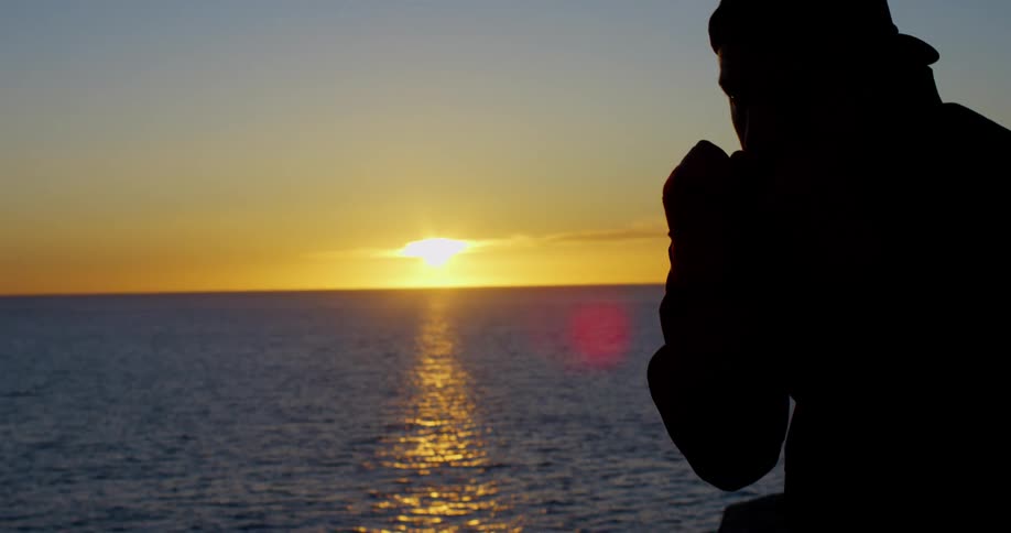 Man boxing at sunset