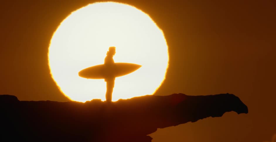 A man standing in front of a sunset