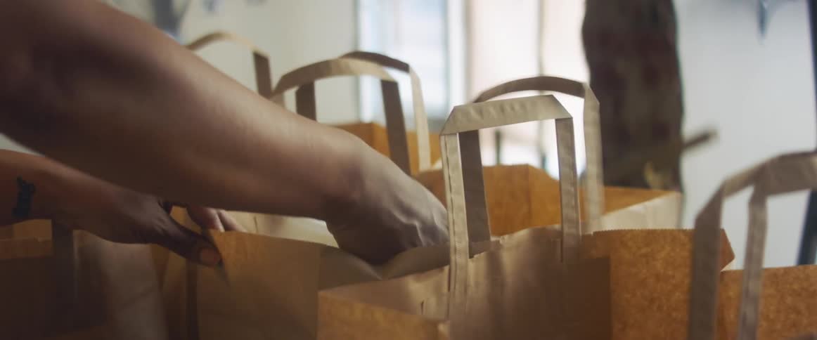 An employee putting items into a bag