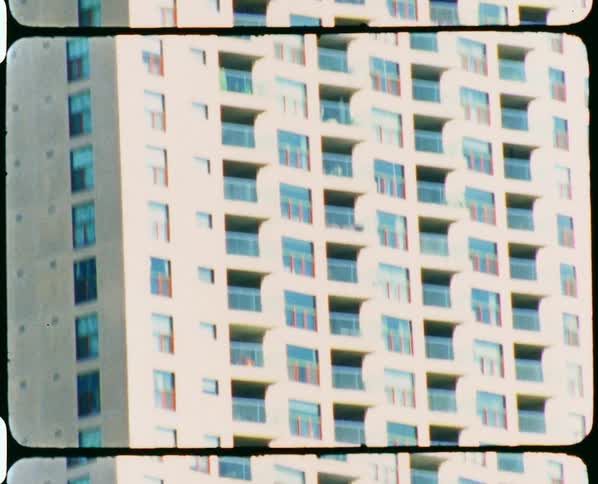 Frames of film move as a building is revealed from the bottom to the top